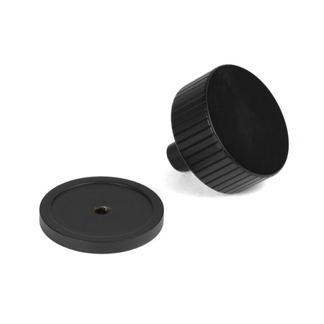 This is an image showing From The Anvil - Matt Black Judd Cabinet Knob - 38mm (Plain) available from trade door handles, quick delivery and discounted prices