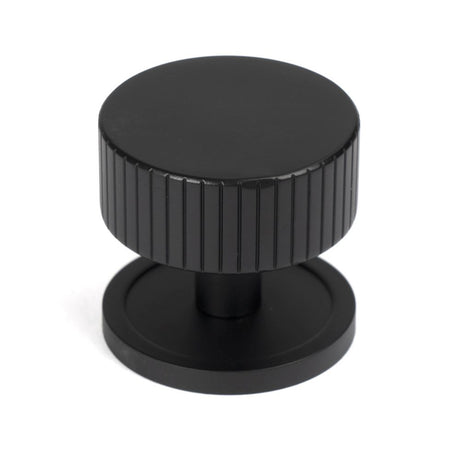 This is an image showing From The Anvil - Matt Black Judd Cabinet Knob - 38mm (Plain) available from trade door handles, quick delivery and discounted prices