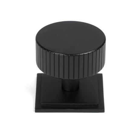 This is an image showing From The Anvil - Matt Black Judd Cabinet Knob - 38mm (Square) available from trade door handles, quick delivery and discounted prices