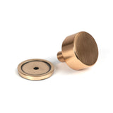 This is an image showing From The Anvil - Polished Bronze Kelso Cabinet Knob - 32mm (Plain) available from trade door handles, quick delivery and discounted prices