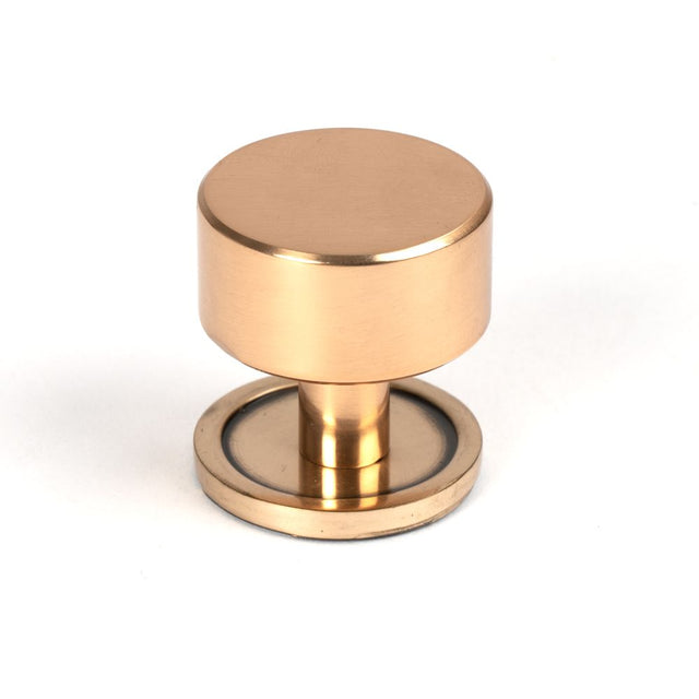 This is an image showing From The Anvil - Polished Bronze Kelso Cabinet Knob - 32mm (Plain) available from trade door handles, quick delivery and discounted prices