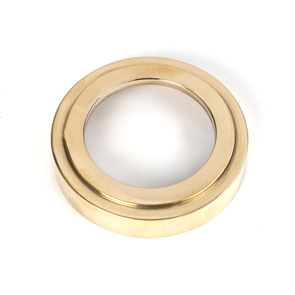 This is an image showing From The Anvil - Polished Brass Round Euro Escutcheon (Art Deco) available from trade door handles, quick delivery and discounted prices