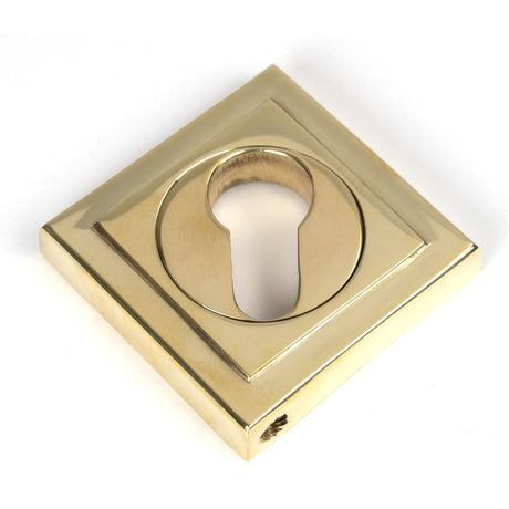 This is an image showing From The Anvil - Polished Brass Round Euro Escutcheon (Square) available from trade door handles, quick delivery and discounted prices