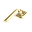 This is an image showing From The Anvil - Polished Brass Avon Round Lever on Rose Set (Square) available from trade door handles, quick delivery and discounted prices