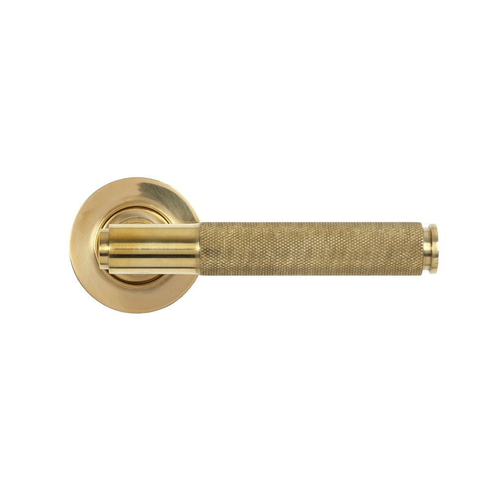 This is an image showing From The Anvil - Polished Brass Brompton Lever on Rose Set (Plain) available from trade door handles, quick delivery and discounted prices