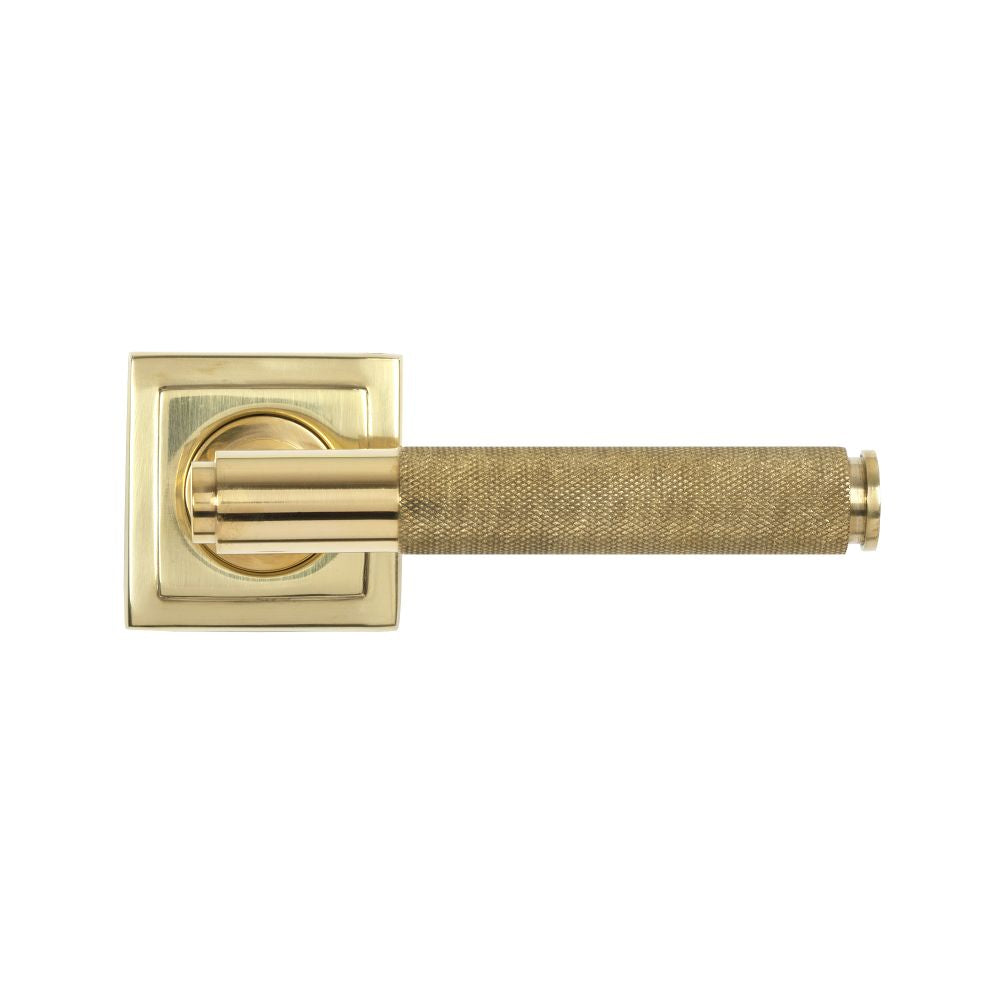 This is an image showing From The Anvil - Polished Brass Brompton Lever on Rose Set (Square) available from trade door handles, quick delivery and discounted prices