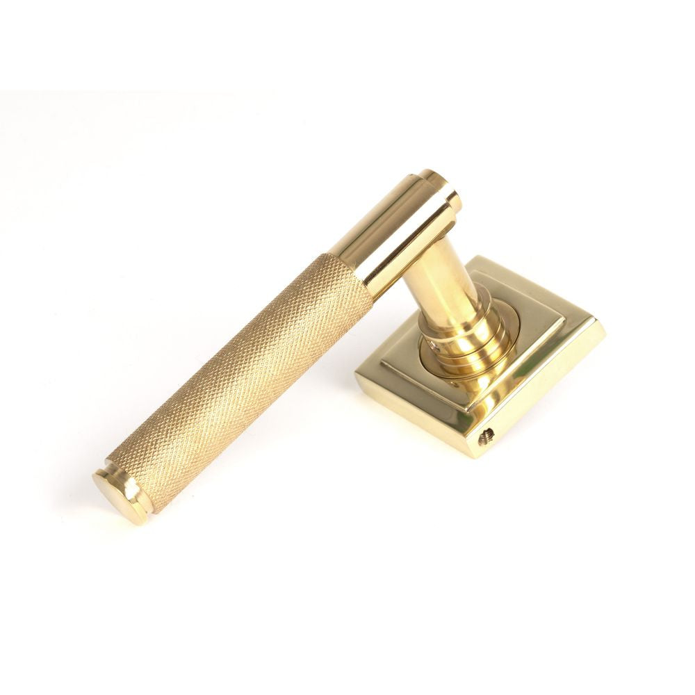 This is an image showing From The Anvil - Polished Brass Brompton Lever on Rose Set (Square) - Unsprung available from trade door handles, quick delivery and discounted prices