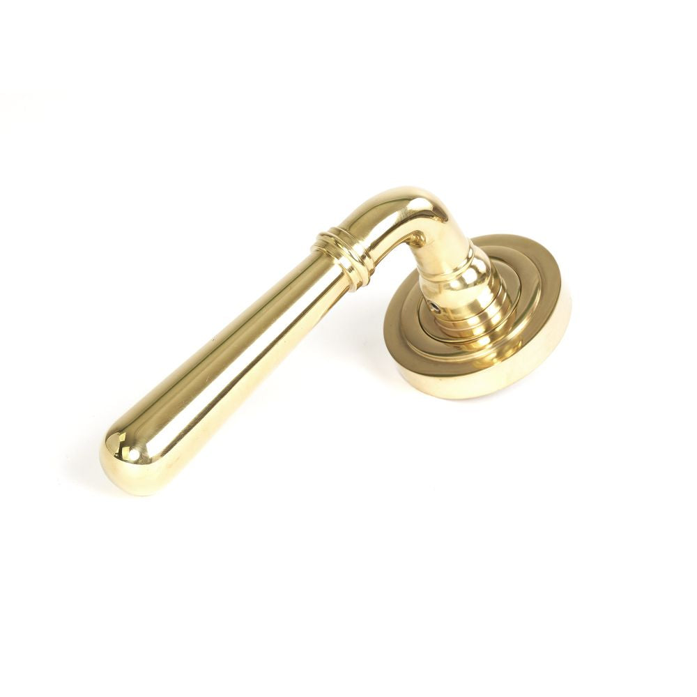 This is an image showing From The Anvil - Polished Brass Newbury Lever on Rose Set (Art Deco) available from trade door handles, quick delivery and discounted prices