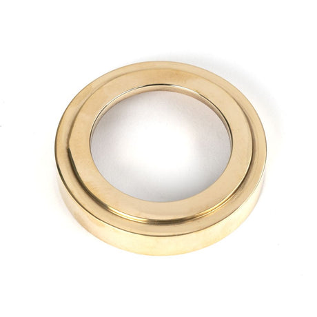 This is an image showing From The Anvil - Polished Brass Round Escutcheon (Art Deco) available from trade door handles, quick delivery and discounted prices