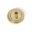 This is an image showing From The Anvil - Polished Brass Round Escutcheon (Art Deco) available from trade door handles, quick delivery and discounted prices