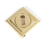 This is an image showing From The Anvil - Polished Brass Round Escutcheon (Square) available from trade door handles, quick delivery and discounted prices