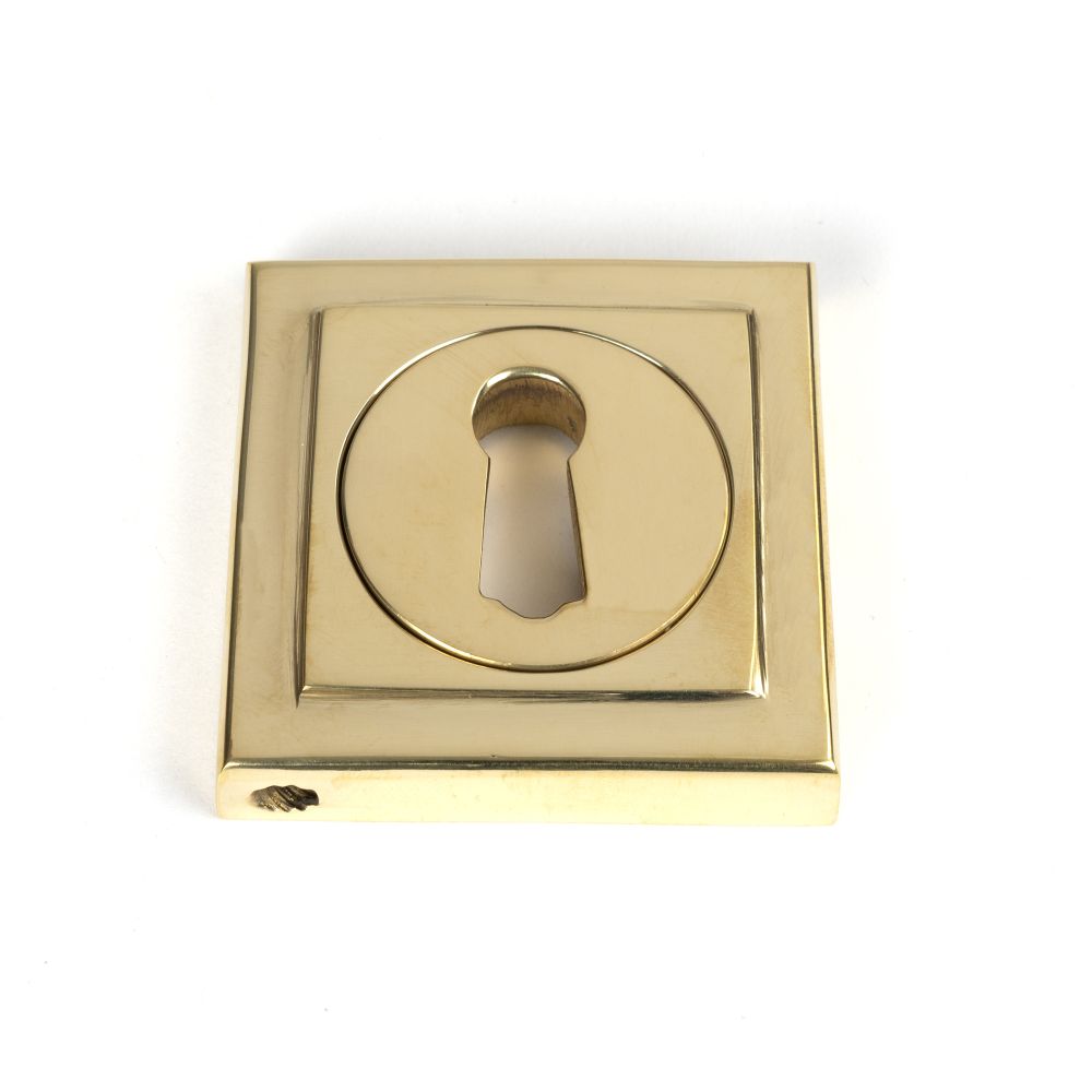 This is an image showing From The Anvil - Polished Brass Round Escutcheon (Square) available from trade door handles, quick delivery and discounted prices