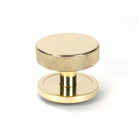 This is an image showing From The Anvil - Polished Brass Brompton Centre Door Knob (Plain) available from trade door handles, quick delivery and discounted prices