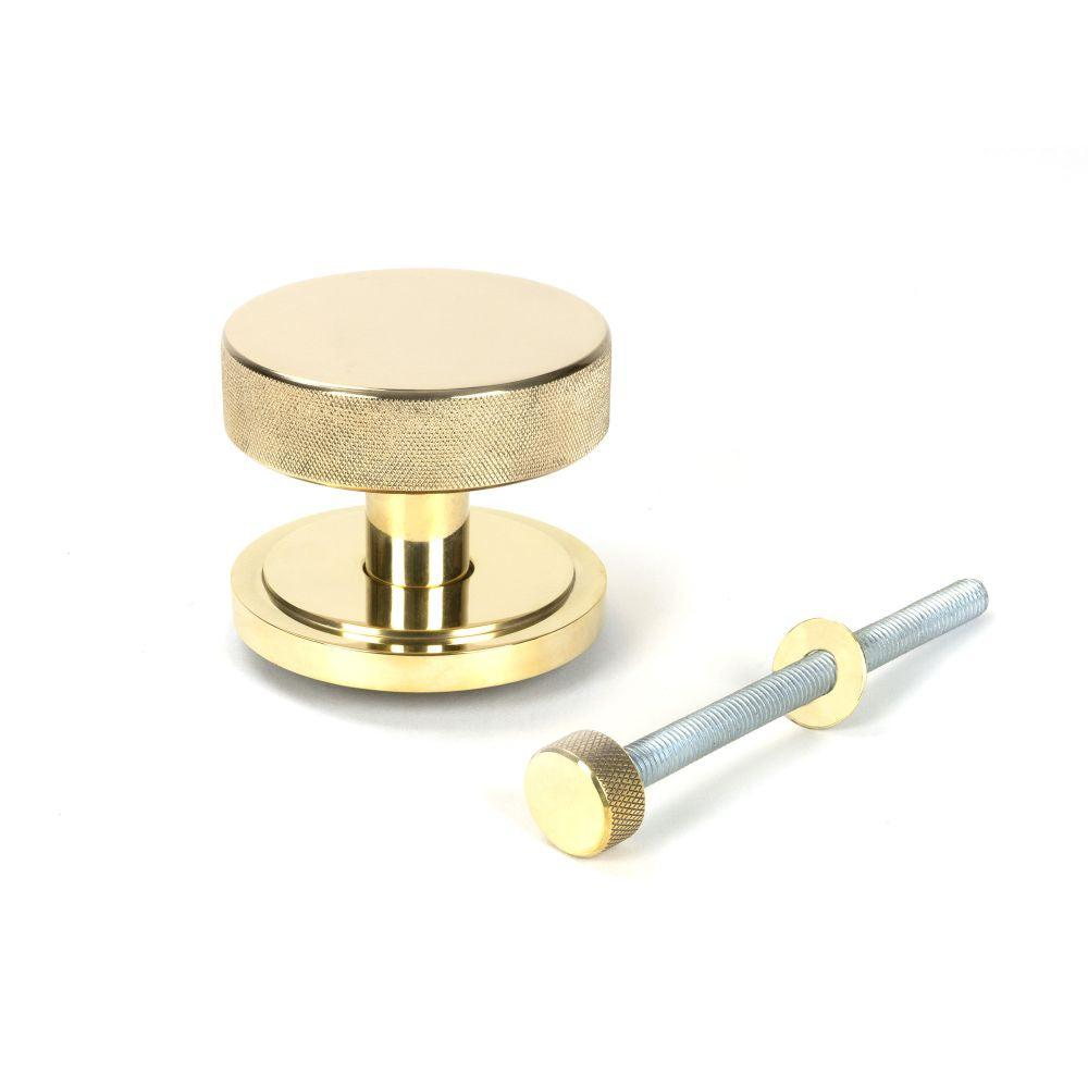 This is an image showing From The Anvil - Polished Brass Brompton Centre Door Knob (Art Deco) available from trade door handles, quick delivery and discounted prices