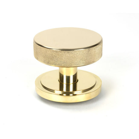 This is an image showing From The Anvil - Polished Brass Brompton Centre Door Knob (Art Deco) available from trade door handles, quick delivery and discounted prices