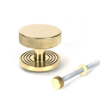 This is an image showing From The Anvil - Polished Brass Brompton Centre Door Knob (Beehive) available from trade door handles, quick delivery and discounted prices