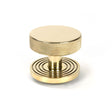 This is an image showing From The Anvil - Polished Brass Brompton Centre Door Knob (Beehive) available from trade door handles, quick delivery and discounted prices