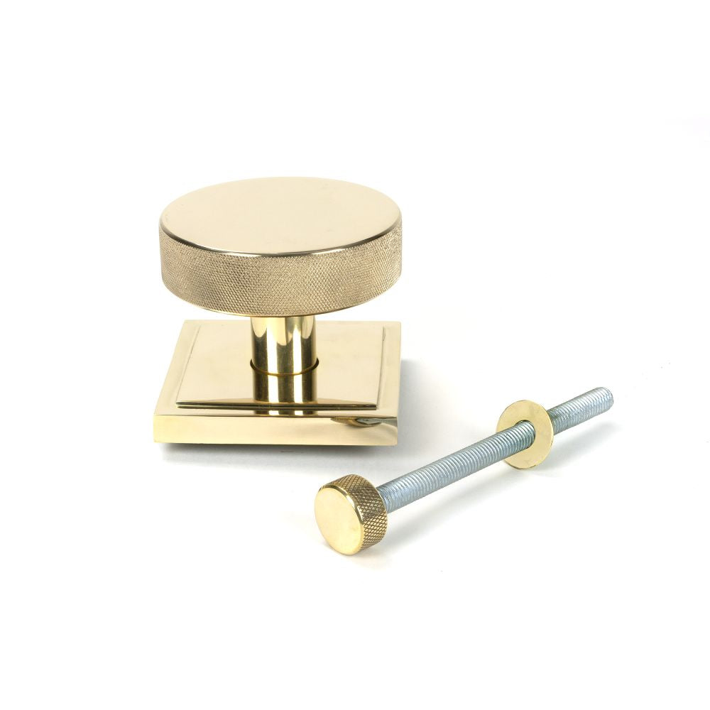 This is an image showing From The Anvil - Polished Brass Brompton Centre Door Knob (Square) available from trade door handles, quick delivery and discounted prices