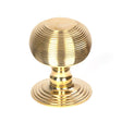 This is an image showing From The Anvil - Polished Brass Beehive Centre Door Knob available from trade door handles, quick delivery and discounted prices