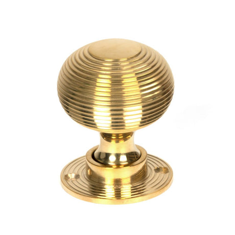 This is an image showing From The Anvil - Polished Brass Heavy Beehive Mortice/Rim Knob Set available from trade door handles, quick delivery and discounted prices