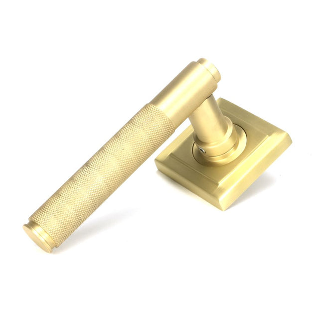 This is an image showing From The Anvil - Satin Brass Brompton Lever on Rose Set (Square) available from trade door handles, quick delivery and discounted prices