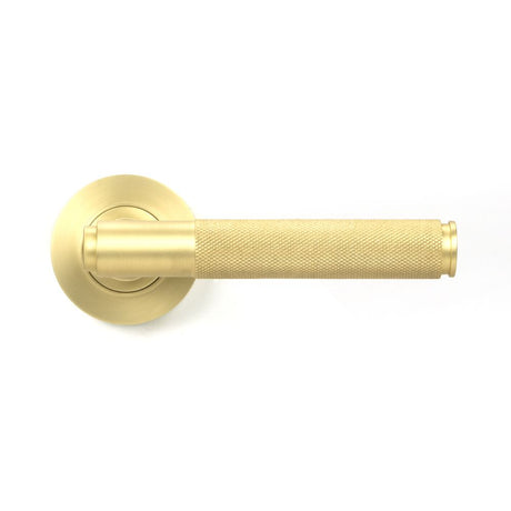 This is an image showing From The Anvil - Satin Brass Brompton Lever on Rose Set (Plain) - Unsprung available from trade door handles, quick delivery and discounted prices