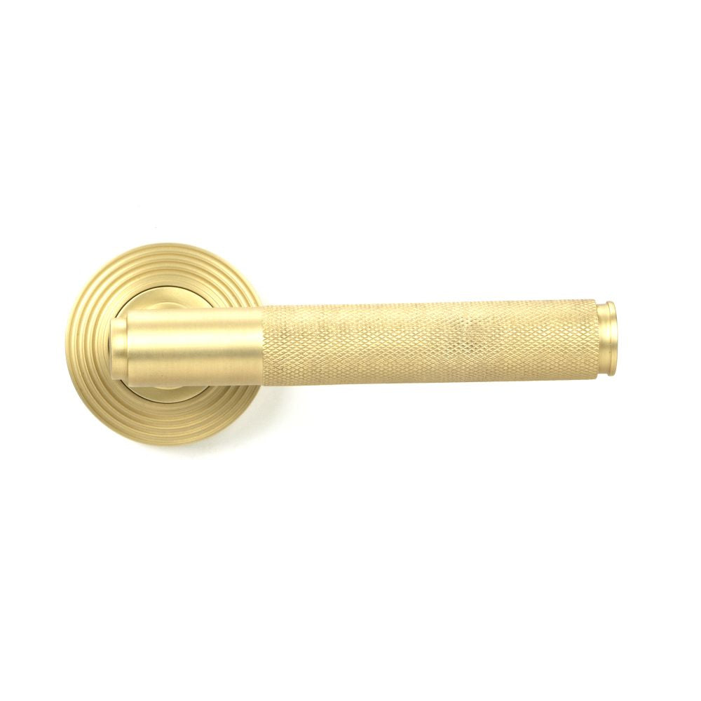 This is an image showing From The Anvil - Satin Brass Brompton Lever on Rose Set (Beehive) - Unsprung available from trade door handles, quick delivery and discounted prices