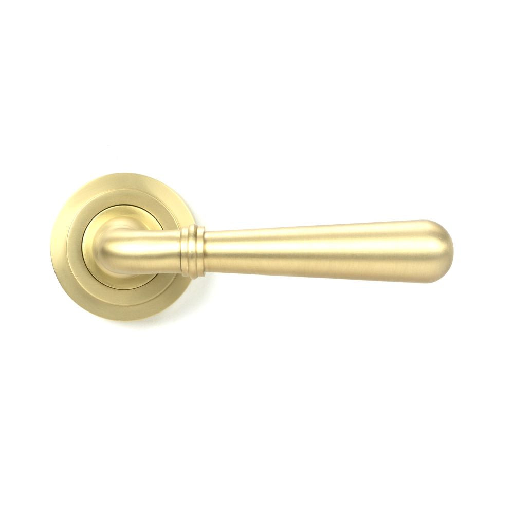 This is an image showing From The Anvil - Satin Brass Newbury Lever on Rose Set (Art Deco) available from trade door handles, quick delivery and discounted prices