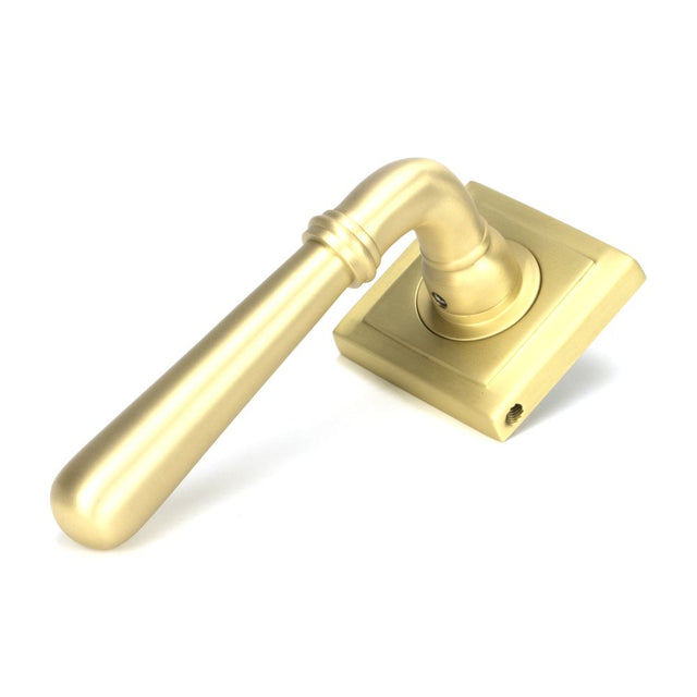 This is an image showing From The Anvil - Satin Brass Newbury Lever on Rose Set (Square) available from trade door handles, quick delivery and discounted prices