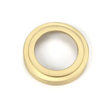 This is an image showing From The Anvil - Satin Brass Round Escutcheon (Art Deco) available from trade door handles, quick delivery and discounted prices