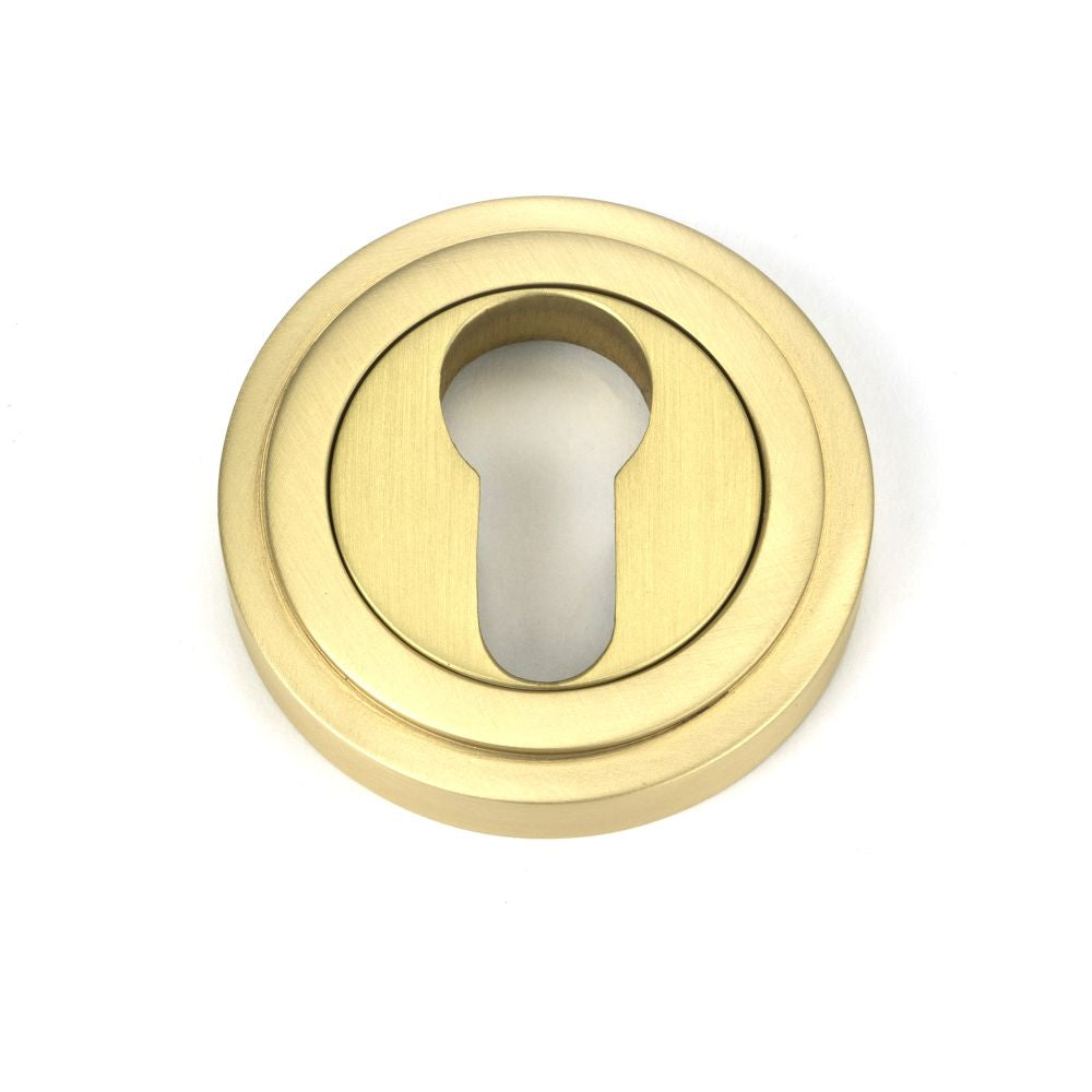 This is an image showing From The Anvil - Satin Brass Round Euro Escutcheon (Art Deco) available from trade door handles, quick delivery and discounted prices