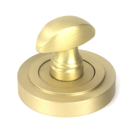 This is an image showing From The Anvil - Satin Brass Round Thumbturn Set (Art Deco) available from trade door handles, quick delivery and discounted prices