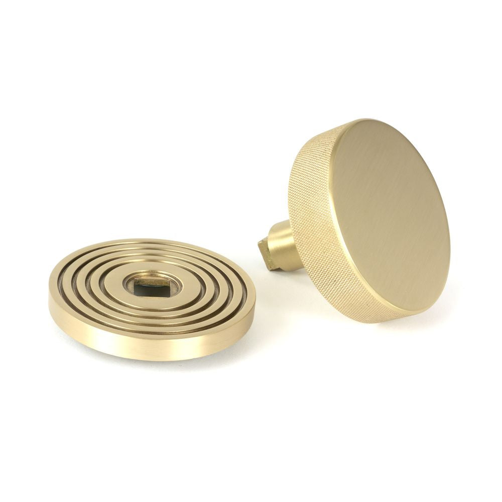 This is an image showing From The Anvil - Satin Brass Brompton Centre Door Knob (Beehive) available from trade door handles, quick delivery and discounted prices