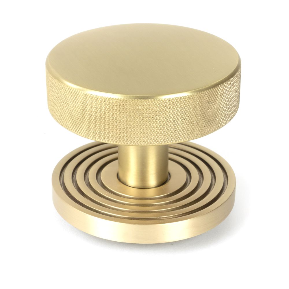 This is an image showing From The Anvil - Satin Brass Brompton Centre Door Knob (Beehive) available from trade door handles, quick delivery and discounted prices