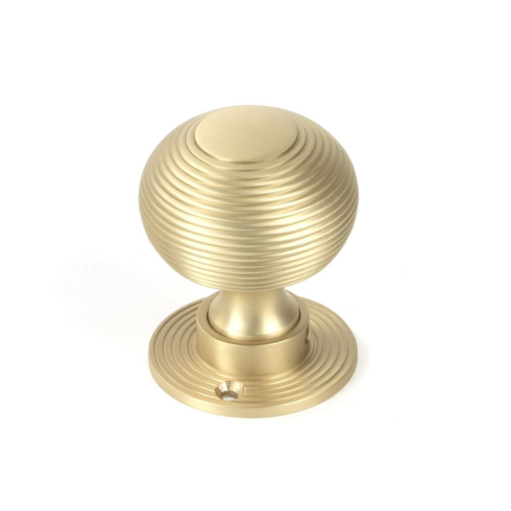 This is an image showing From The Anvil - Satin Brass Heavy Beehive Mortice/Rim Knob Set available from trade door handles, quick delivery and discounted prices