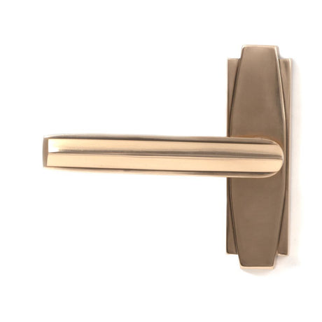 This is an image showing From The Anvil - Polished Bronze Art Deco Lever on Rose Set available from trade door handles, quick delivery and discounted prices