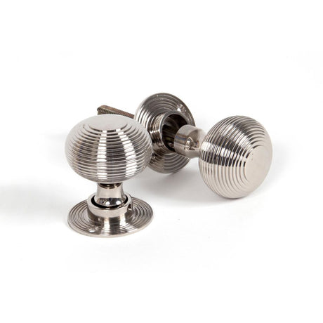 This is an image showing From The Anvil - Polished Nickel Heavy Beehive Mortice/Rim Knob Set available from trade door handles, quick delivery and discounted prices