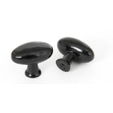 This is an image showing From The Anvil - Black Oval Cabinet Knob available from trade door handles, quick delivery and discounted prices