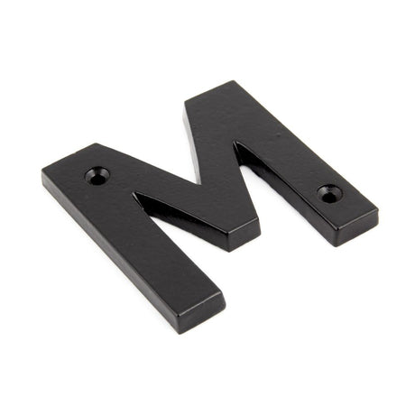 This is an image showing From The Anvil - Black Letter M available from trade door handles, quick delivery and discounted prices