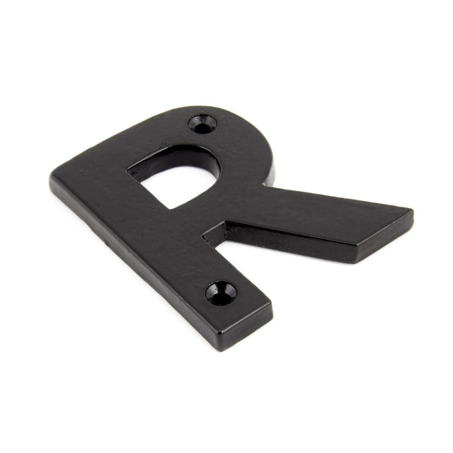 This is an image showing From The Anvil - Black Letter R available from trade door handles, quick delivery and discounted prices