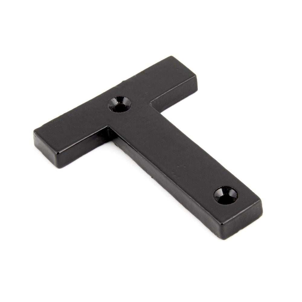 This is an image showing From The Anvil - Black Letter T available from trade door handles, quick delivery and discounted prices