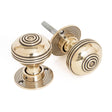 This is an image showing From The Anvil - Aged Brass 50mm Prestbury Mortice/Rim Knob Set available from trade door handles, quick delivery and discounted prices