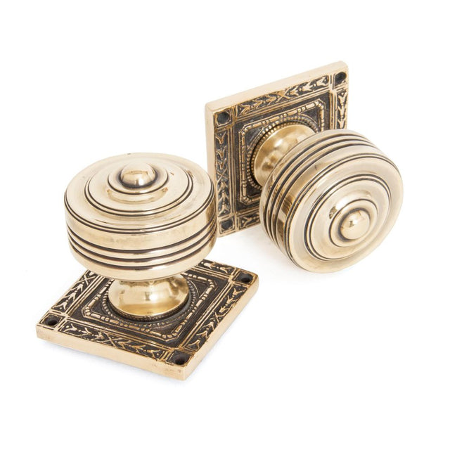 This is an image showing From The Anvil - Aged Brass Tewkesbury Square Mortice Knob Set available from trade door handles, quick delivery and discounted prices