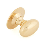 This is an image showing From The Anvil - Polished Brass Oval Cabinet Knob 40mm available from trade door handles, quick delivery and discounted prices