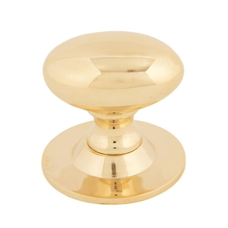 This is an image showing From The Anvil - Polished Brass Oval Cabinet Knob 40mm available from trade door handles, quick delivery and discounted prices