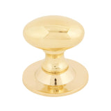 This is an image showing From The Anvil - Polished Brass Oval Cabinet Knob 33mm available from trade door handles, quick delivery and discounted prices