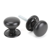 This is an image showing From The Anvil - Aged Bronze Mushroom Mortice/Rim Knob Set available from trade door handles, quick delivery and discounted prices