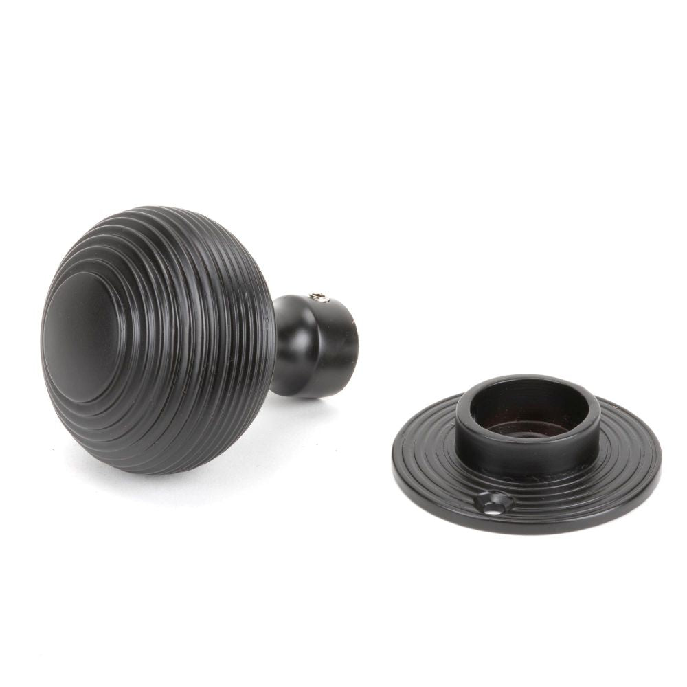 This is an image showing From The Anvil - Aged Bronze Heavy Beehive Mortice/Rim Knob Set available from trade door handles, quick delivery and discounted prices