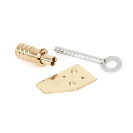 This is an image showing From The Anvil - Polished Brass Key-Flush Sash Stop available from trade door handles, quick delivery and discounted prices