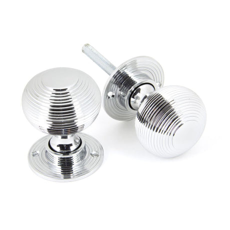 This is an image showing From The Anvil - Polished Chrome Heavy Beehive Mortice/Rim Knob Set available from trade door handles, quick delivery and discounted prices